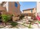 Inviting backyard featuring a water feature, charming patio furniture, and lush landscaping at 1153 E Muirwood Dr, Phoenix, AZ 85048