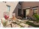 Outdoor patio space with comfortable seating, potted plants, and charming decor for relaxing or entertaining at 1153 E Muirwood Dr, Phoenix, AZ 85048