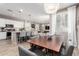 Open dining area with modern lighting seamlessly blending with a well-equipped kitchen and cozy living space at 1153 E Muirwood Dr, Phoenix, AZ 85048