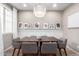 Stylish dining room with modern chandelier, neutral paint, and seating for four, perfect for intimate meals at 1153 E Muirwood Dr, Phoenix, AZ 85048