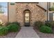 Inviting entrance with a stone-framed doorway and meticulously designed front landscaping at 1153 E Muirwood Dr, Phoenix, AZ 85048