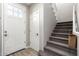 Bright foyer showcasing a staircase, neutral walls, and a modern door, offering a seamless transition into the home at 1153 E Muirwood Dr, Phoenix, AZ 85048