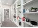 Bright hallway featuring built-in shelving filled with books and decorative items, adding character and storage at 1153 E Muirwood Dr, Phoenix, AZ 85048