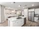 Bright kitchen featuring stainless steel appliances and kitchen island with breakfast bar at 1153 E Muirwood Dr, Phoenix, AZ 85048