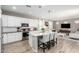 Modern kitchen with stainless steel appliances, white cabinets and center island with seating at 1153 E Muirwood Dr, Phoenix, AZ 85048