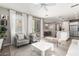 Open-concept living space with light-colored decor, large windows, and seamless flow to adjacent spaces at 1153 E Muirwood Dr, Phoenix, AZ 85048
