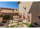 Charming backyard patio with a seating area, decorative trellis, and water feature at 1153 E Muirwood Dr, Phoenix, AZ 85048