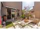 Relaxing patio with bistro set, water feature, and lush greenery at 1153 E Muirwood Dr, Phoenix, AZ 85048