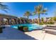 Community pool with palm trees, lounge chairs, and pergola at 1153 E Muirwood Dr, Phoenix, AZ 85048