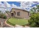 Charming backyard featuring a personal putting green and desert landscaping, ideal for outdoor enjoyment at 1154 E Kramer Cir, Mesa, AZ 85203
