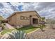 Landscaped backyard features synthetic grass, gravel beds, and desert plants, providing a low-maintenance outdoor space at 1154 E Kramer Cir, Mesa, AZ 85203