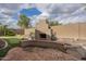 Backyard view showcasing the cozy outdoor fireplace and putting green, perfect for entertaining and relaxation at 1154 E Kramer Cir, Mesa, AZ 85203