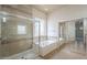 En suite bathroom with a glass-enclosed shower, soaking tub, and sliding mirror closet doors at 1154 E Kramer Cir, Mesa, AZ 85203