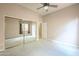 Spacious bedroom with carpet, ceiling fan and mirrored closet doors at 1154 E Kramer Cir, Mesa, AZ 85203