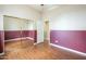 Roomy bedroom with laminate wood floor, closet with mirrored doors and view to entry at 1154 E Kramer Cir, Mesa, AZ 85203