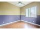 Inviting bedroom features a ceiling fan, and laminate wood flooring at 1154 E Kramer Cir, Mesa, AZ 85203