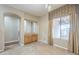 Traditional dining room with tile flooring, a built-in cabinet and a large window at 1154 E Kramer Cir, Mesa, AZ 85203