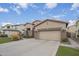 Front exterior view of a stucco home with desert landscaping and a long driveway at 1154 E Kramer Cir, Mesa, AZ 85203
