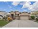 A large 3-car garage on a single Gathering home with well maintained front yard and landscaping at 1154 E Kramer Cir, Mesa, AZ 85203
