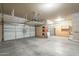 Spacious three car garage offering parking and storage with bright lighting, and shelving at 1154 E Kramer Cir, Mesa, AZ 85203