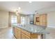 Bright, open kitchen with an island featuring a sink and a view into the living area at 1154 E Kramer Cir, Mesa, AZ 85203