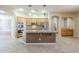 Bright kitchen with an island, stainless steel appliances, double ovens, and tile floors at 1154 E Kramer Cir, Mesa, AZ 85203
