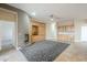 Spacious living room featuring a fireplace and built-in cabinetry with stylish tile flooring and contemporary ceiling fan at 1154 E Kramer Cir, Mesa, AZ 85203