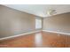 An open living room with wood flooring, beige walls, and a ceiling fan at 1154 E Kramer Cir, Mesa, AZ 85203