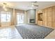 Comfortable living room with a fireplace, large windows, and built-in cabinets and shelves at 1154 E Kramer Cir, Mesa, AZ 85203