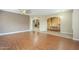 Spacious living room with wood floors and neutral paint, connecting to the office at 1154 E Kramer Cir, Mesa, AZ 85203