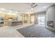Open-concept living area with kitchen, fireplace, ceiling fan, and sliding glass doors to the patio at 1154 E Kramer Cir, Mesa, AZ 85203