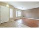 A open, carpetless living room with light-colored walls and large windows with shutters at 1154 E Kramer Cir, Mesa, AZ 85203