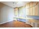 Office room with light wood built-in shelves and desk, accented by a world map at 1154 E Kramer Cir, Mesa, AZ 85203