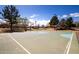 Community basketball court with hoops, flags, and nearby trees at 12240 W Scotts Dr, El Mirage, AZ 85335