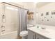 Bathroom featuring a shower-tub combo and decor shelves at 12240 W Scotts Dr, El Mirage, AZ 85335