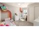 Bright bedroom featuring a window and rainbow-painted wall at 12240 W Scotts Dr, El Mirage, AZ 85335