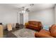Spacious living room featuring hardwood floors, ceiling fan, and stylish furniture at 12240 W Scotts Dr, El Mirage, AZ 85335