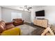 Spacious living room featuring hardwood floors, ceiling fan, and stylish furniture at 12240 W Scotts Dr, El Mirage, AZ 85335