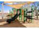 Community playground with green and orange play equipment and slide at 12240 W Scotts Dr, El Mirage, AZ 85335