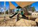 Community playground with shaded play equipment, slide and climbing wall at 12240 W Scotts Dr, El Mirage, AZ 85335