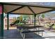 Community playground with shaded seating area and play equipment at 12240 W Scotts Dr, El Mirage, AZ 85335