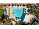 Aerial view of a well-maintained community pool area with ample lounge seating and shaded areas at 12839 W Rincon Ct, Sun City West, AZ 85375