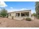 Spacious backyard featuring a covered patio and beautifully landscaped with flowers and shrubbery at 12839 W Rincon Ct, Sun City West, AZ 85375