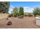 Beautifully landscaped backyard with gravel ground cover, mature shade trees and desert shrubbery at 12839 W Rincon Ct, Sun City West, AZ 85375