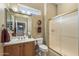 Well-lit bathroom features a vanity, toilet, and shower with glass door at 12839 W Rincon Ct, Sun City West, AZ 85375