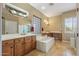 Large bathroom features soaking tub, shower, and double vanity at 12839 W Rincon Ct, Sun City West, AZ 85375