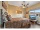 This bedroom features a ceiling fan, natural light, and a unique decorative style, making it a cozy retreat at 12839 W Rincon Ct, Sun City West, AZ 85375