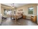 Spacious bedroom with wood floors and large windows leading to a patio at 12839 W Rincon Ct, Sun City West, AZ 85375