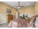 Bedroom showcases a ceiling fan, wood floors, and a cozy bed, ensuring a relaxed and inviting ambiance at 12839 W Rincon Ct, Sun City West, AZ 85375