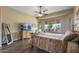 Bedroom with ceiling fan, wood floors, and views of outdoor patio at 12839 W Rincon Ct, Sun City West, AZ 85375